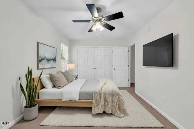 an empty room with a window and a fan
