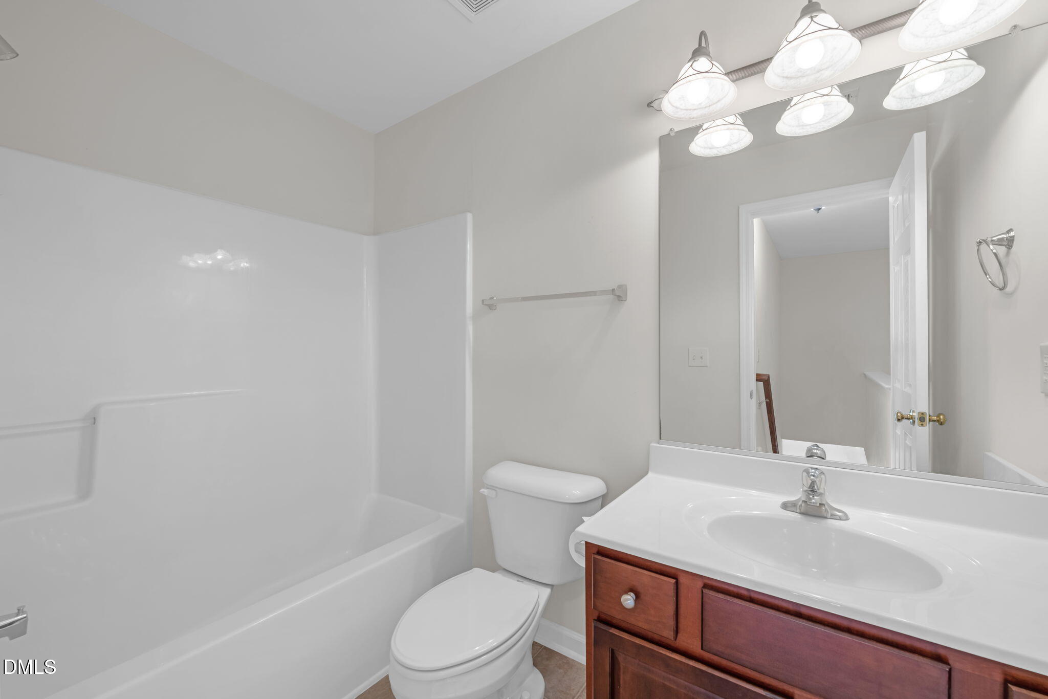 12014 Fox Valley Street Raleigh, NC 27614 - Photo 27 of 42 a bathroom with a sink vanity mirror and toilet