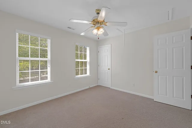 a view of a small space with wooden floor and a window