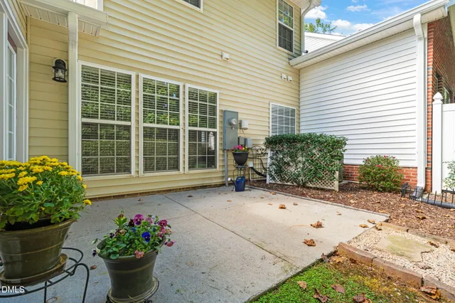 a pathway of a house with a yard