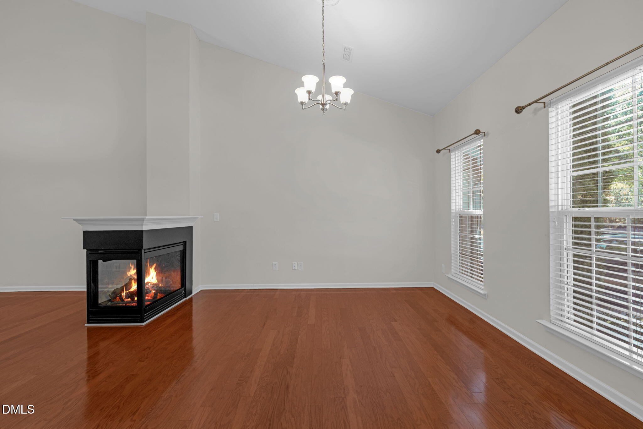12014 Fox Valley Street Raleigh, NC 27614 - Photo 4 of 42 a view of an empty room with wooden floor fireplace and a window