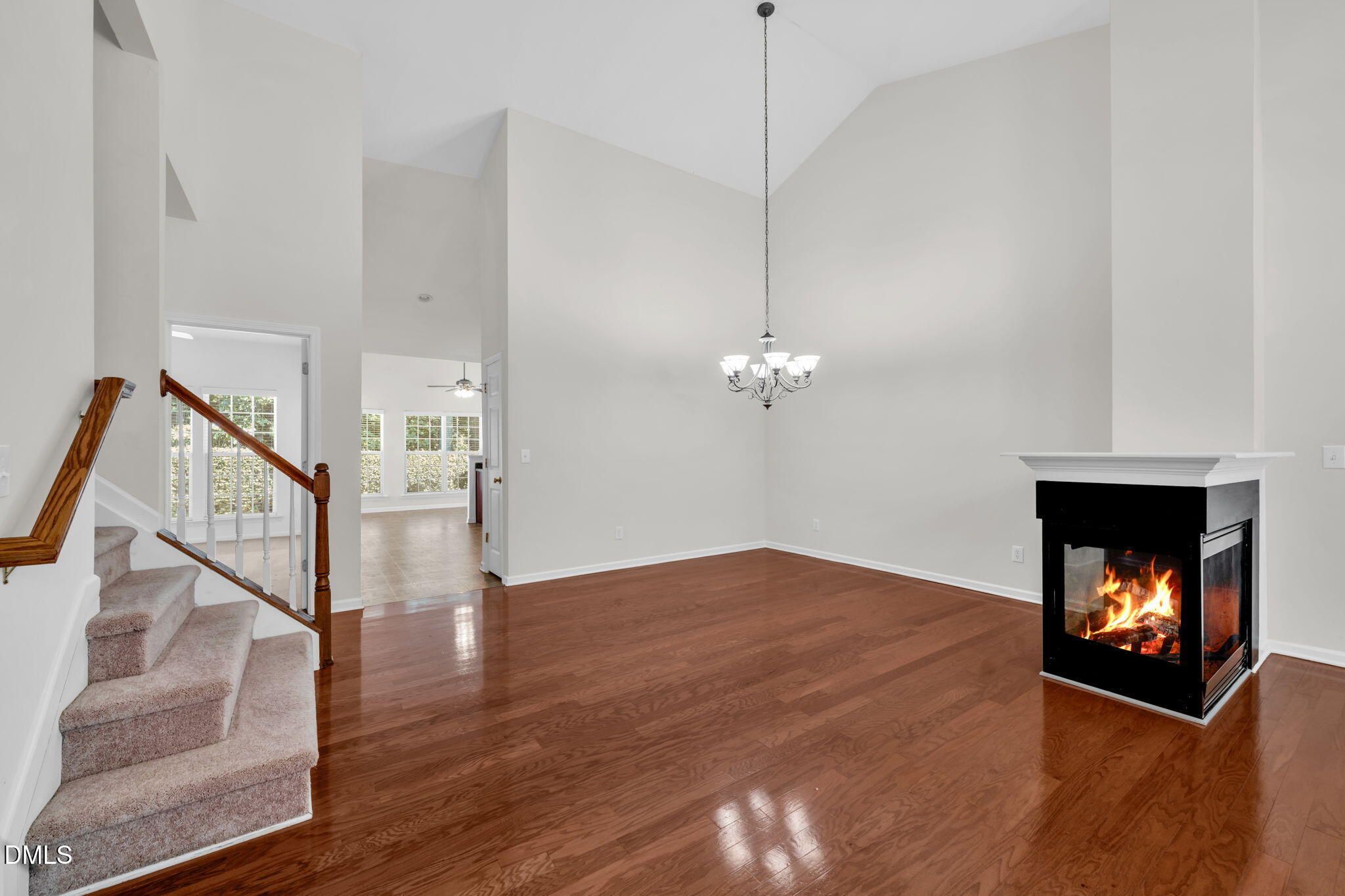 12014 Fox Valley Street Raleigh, NC 27614 - Photo 7 of 42 a view of an empty room with wooden floor fireplace and a window