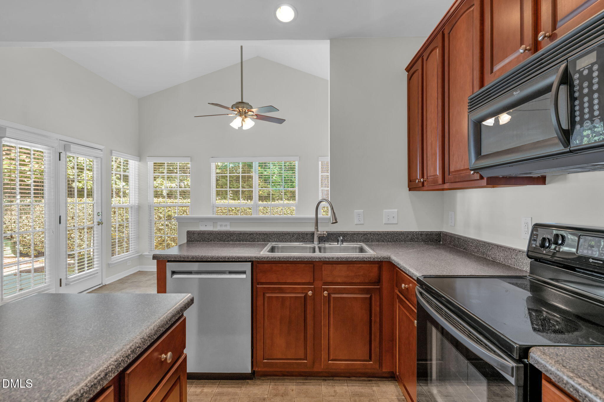 12014 Fox Valley Street Raleigh, NC 27614 - Photo 9 of 42 a kitchen with stainless steel appliances granite countertop a sink a stove counter space and cabinets
