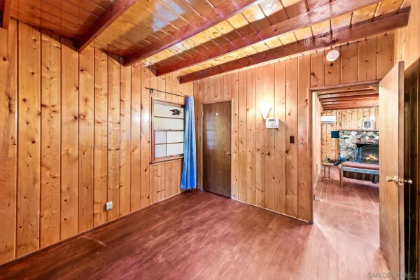 a bedroom with furniture and wooden floor
