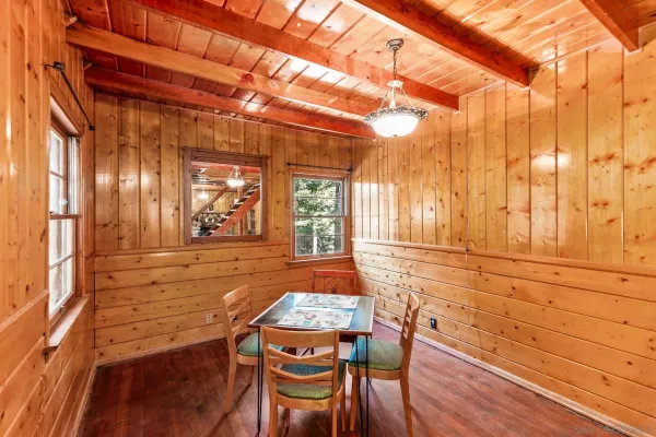 a view of a room with wooden floor and furniture