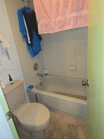 a bathroom with a toilet and a bathtub