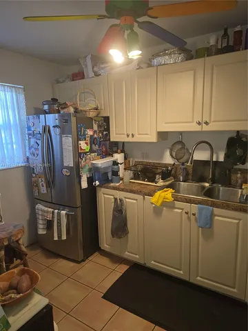 a kitchen with stainless steel appliances granite countertop a sink refrigerator and cabinets