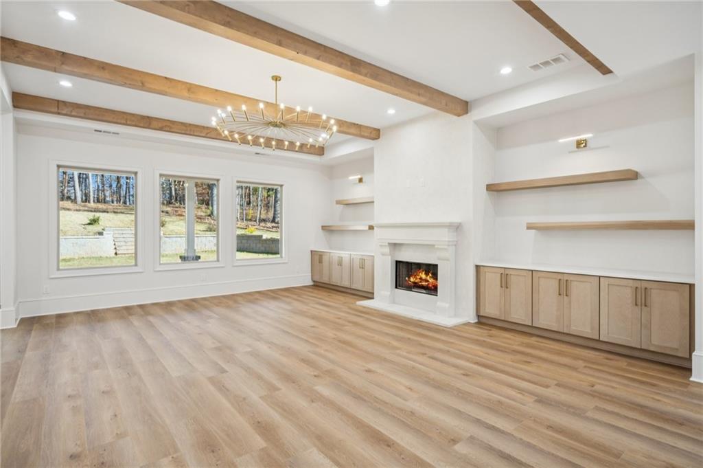 4546 Fawn Path Gainesville, GA 30506 - Photo 13 of 64 a view of an empty room with a fireplace and a window