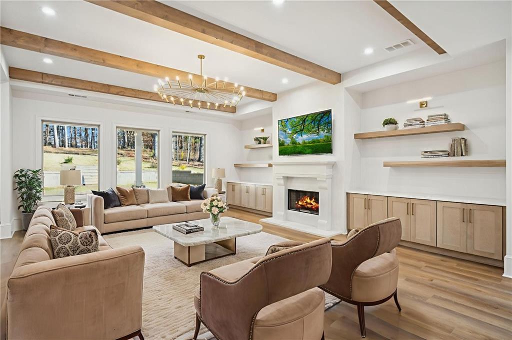 4546 Fawn Path Gainesville, GA 30506 - Photo 14 of 64 a living room with furniture a fireplace and a flat screen tv