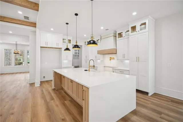 a kitchen with stainless steel appliances a stove a sink and a refrigerator