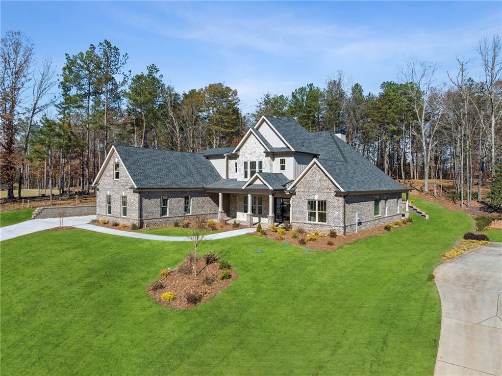 4546 Fawn Path Gainesville, GA 30506 - Photo 2 of 64 a front view of a house with a garden and trees