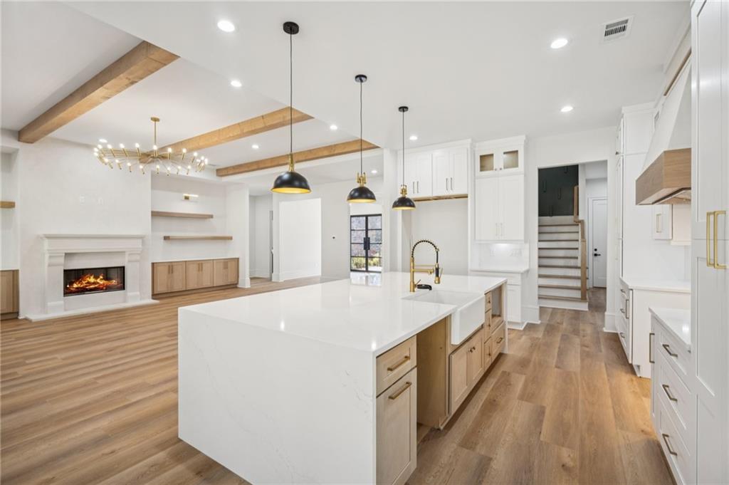 4546 Fawn Path Gainesville, GA 30506 - Photo 21 of 64 a large white kitchen with a stove a sink dishwasher and a refrigerator with wooden floor