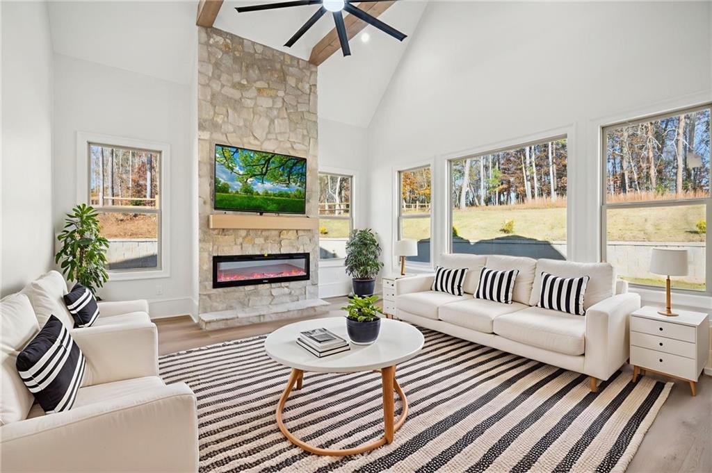 4546 Fawn Path Gainesville, GA 30506 - Photo 26 of 64 a living room with furniture a fireplace and a floor to ceiling window