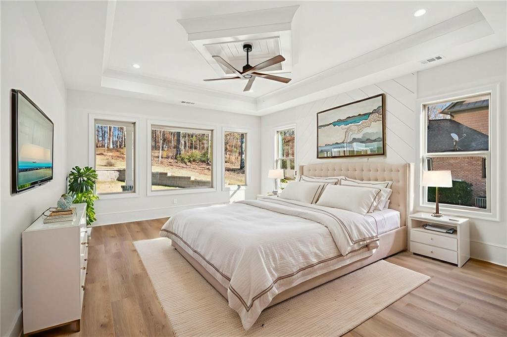 4546 Fawn Path Gainesville, GA 30506 - Photo 31 of 64 a spacious bedroom with a large bed and a chandelier