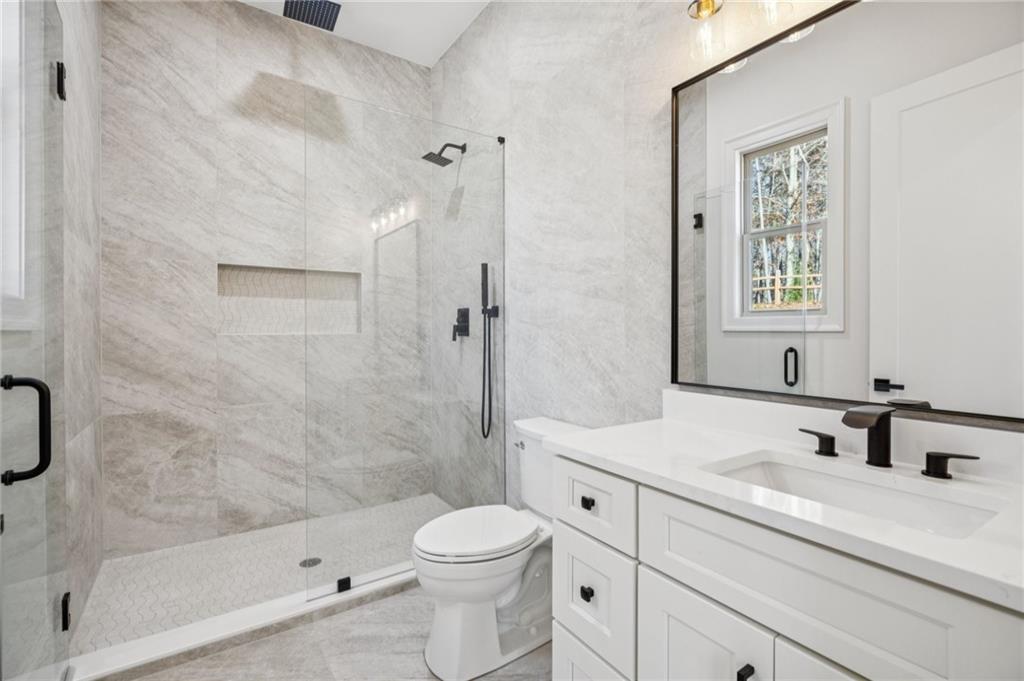 4546 Fawn Path Gainesville, GA 30506 - Photo 39 of 64 a bathroom with a sink a toilet and shower