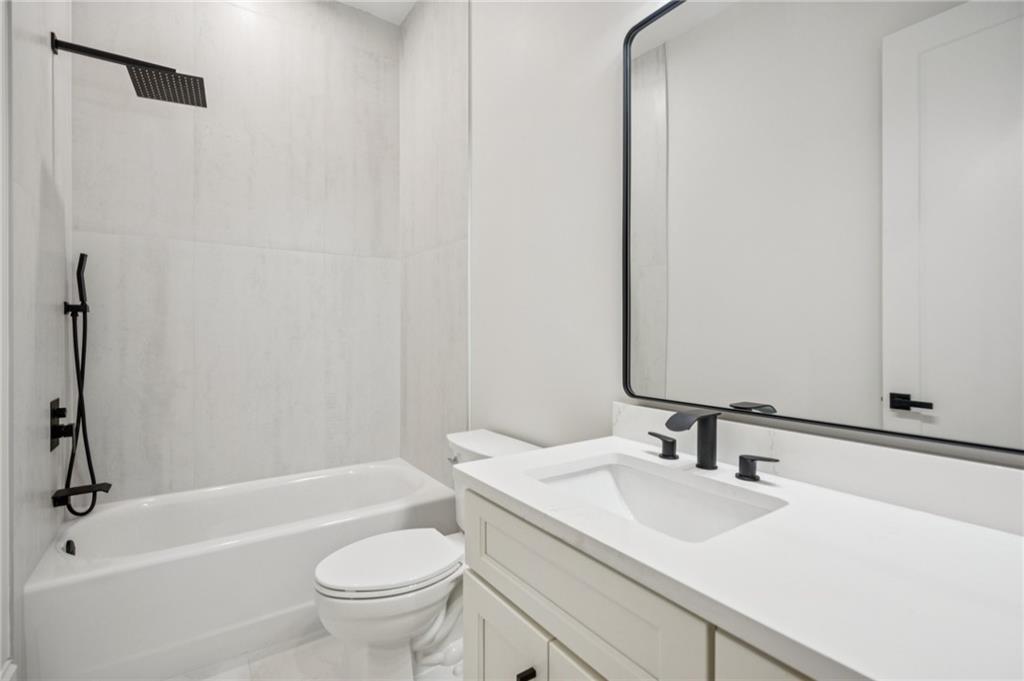 4546 Fawn Path Gainesville, GA 30506 - Photo 49 of 64 a bathroom with a sink a toilet and a mirror