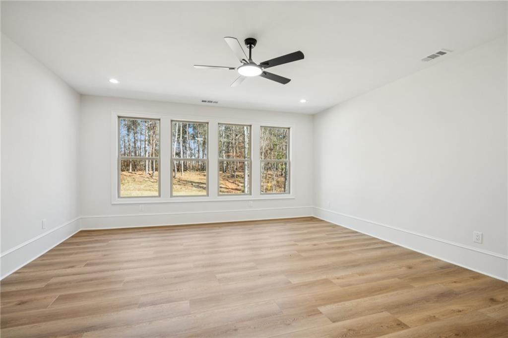 4546 Fawn Path Gainesville, GA 30506 - Photo 50 of 64 a view of an empty room with wooden floor and a window