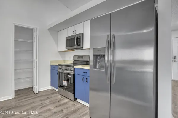 a kitchen with stainless steel appliances granite countertop a refrigerator and a stove