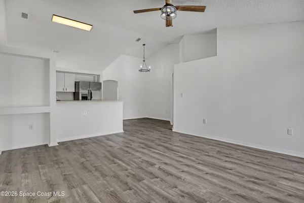 a view of a kitchen with wooden floor and a sink