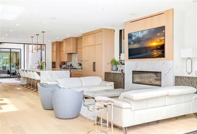 a large white kitchen with a large window and stainless steel appliances