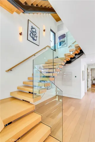 a bedroom with a bed and painting on the wall