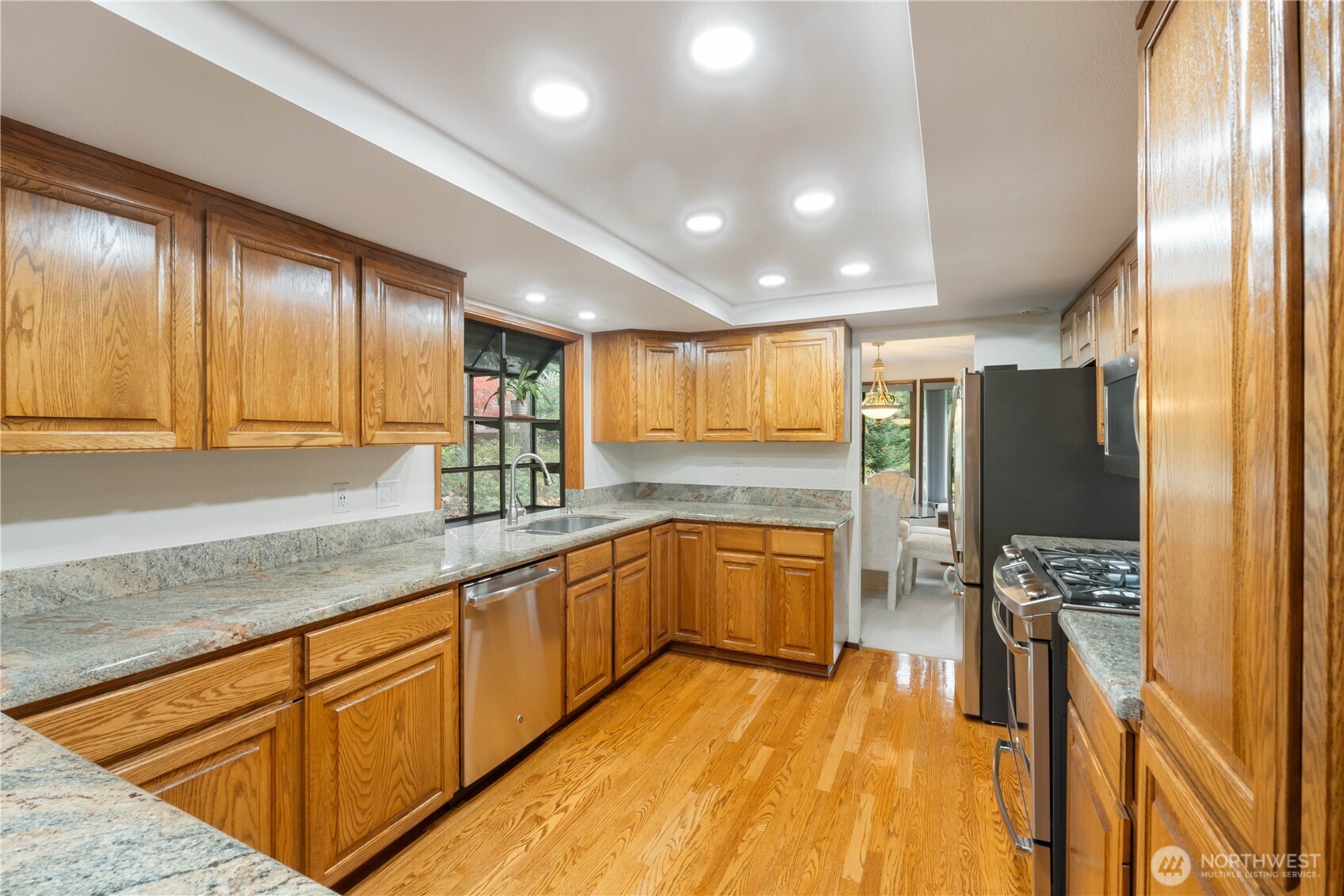 36607 9th Avenue Southwest Federal Way, WA 98023 - Photo 12 of 40 a large kitchen with stainless steel appliances kitchen island granite countertop a large counter top cabinets and stainless steel appliances