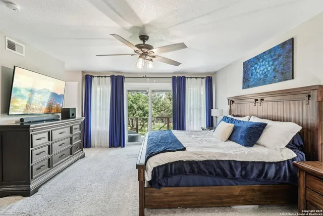 a bedroom with a large bed and a flat screen tv