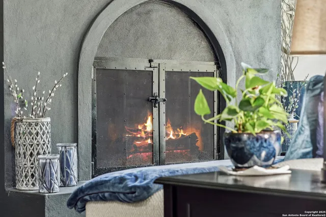a vase of flowers sitting on a table with window