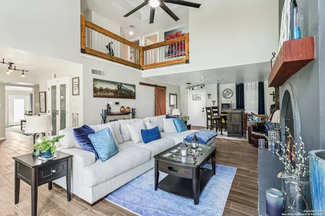 a living room with furniture a rug and a chandelier
