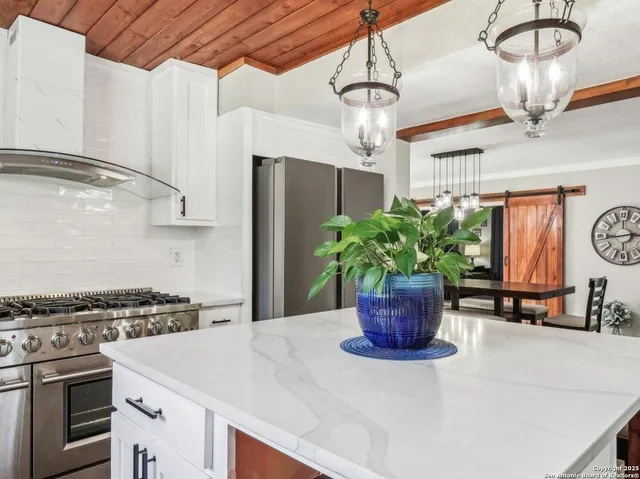 a kitchen with a refrigerator and a stove