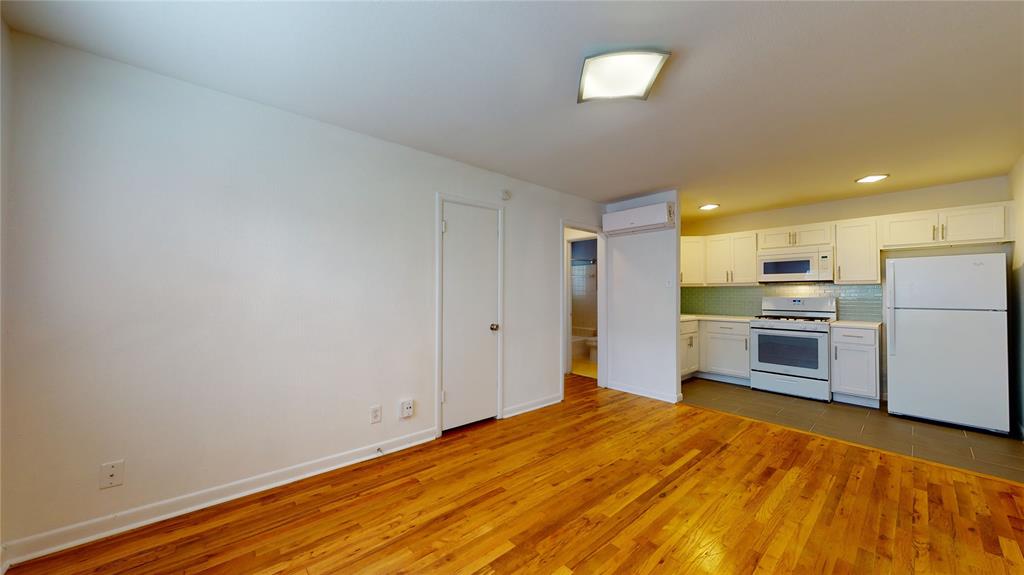 2405 Abrams Road, Unit A1 Dallas, TX 75214 - Photo 3 of 9 a kitchen with stainless steel appliances a refrigerator and a stove top oven