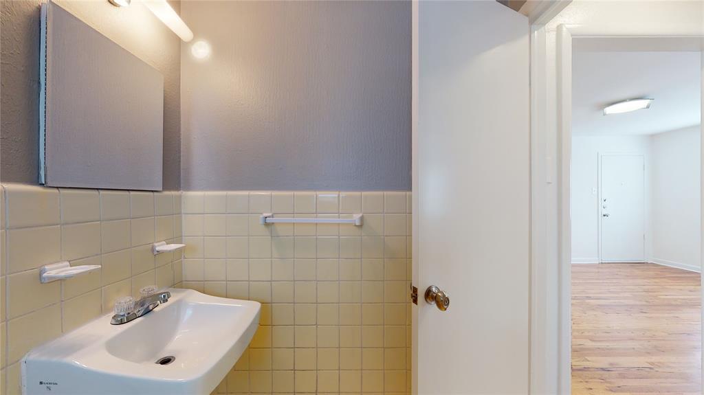 2405 Abrams Road, Unit A1 Dallas, TX 75214 - Photo 9 of 9 a bathroom with a sink mirror and shower