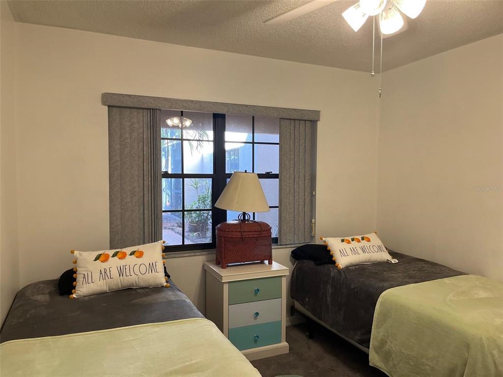 23465 Harbor View Road, Unit 1006 Punta Gorda, FL 33980 - Photo 23 of 41 a bedroom with a bed and a chandelier