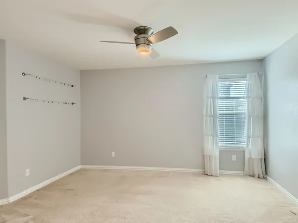 a view of an empty room with chandelier