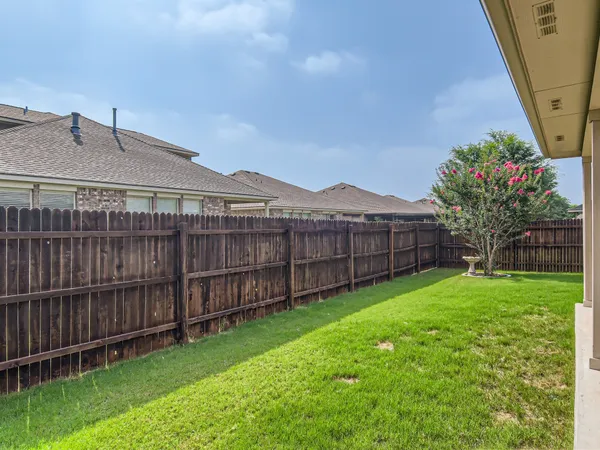 a view of a house with a yard and porch