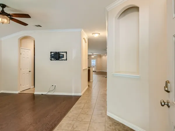 a view of a hallway with wooden floor