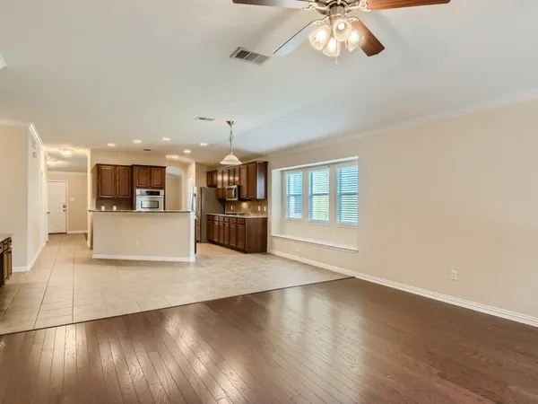 a view of a livingroom with a ceiling fan and window