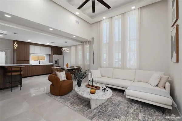 a living room with furniture and kitchen view