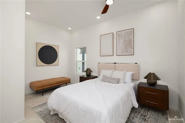 a bedroom with a bed and a large mirror