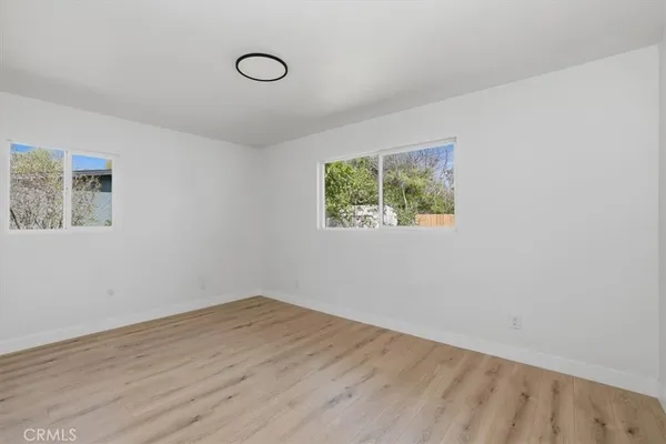 a view of room with wooden floor and window