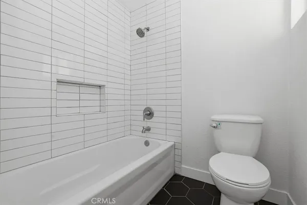 a bathroom with a toilet and bathtub