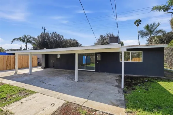 a view of a house with a backyard and a garage