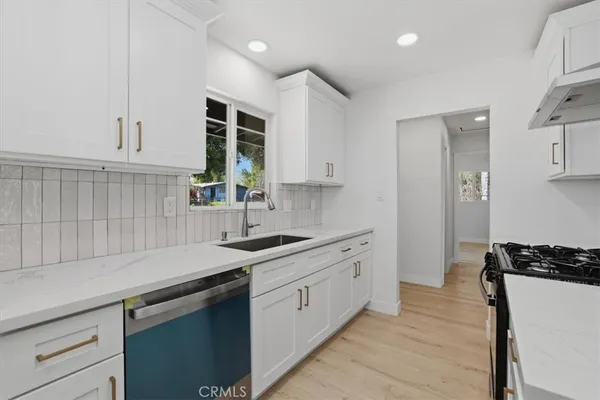 a kitchen with a sink stove and cabinets