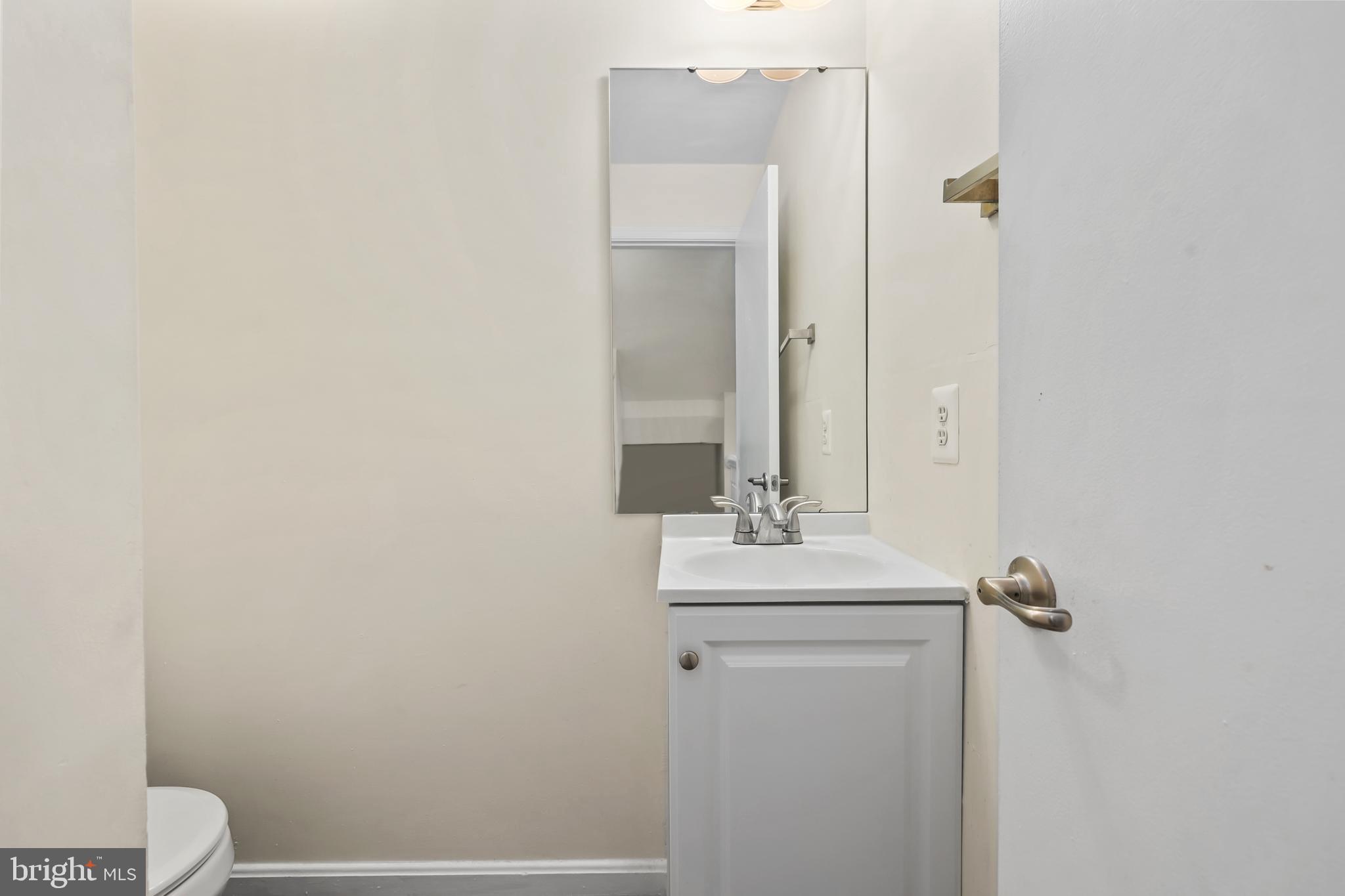 15372 Gunsmith Terrace Woodbridge, VA 22191 - Photo 11 of 37 a bathroom with a sink a toilet and mirror