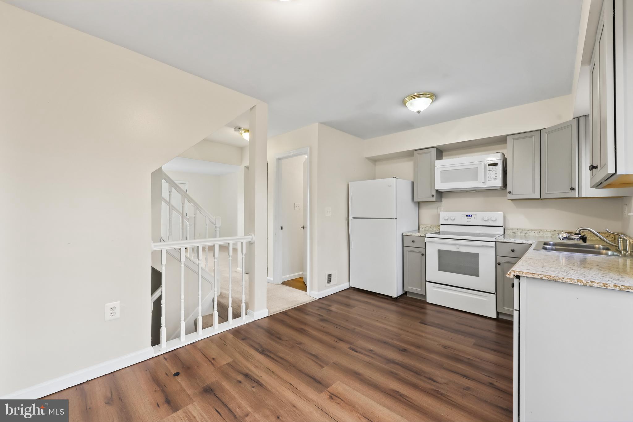 15372 Gunsmith Terrace Woodbridge, VA 22191 - Photo 9 of 37 a kitchen with white cabinets and white appliances