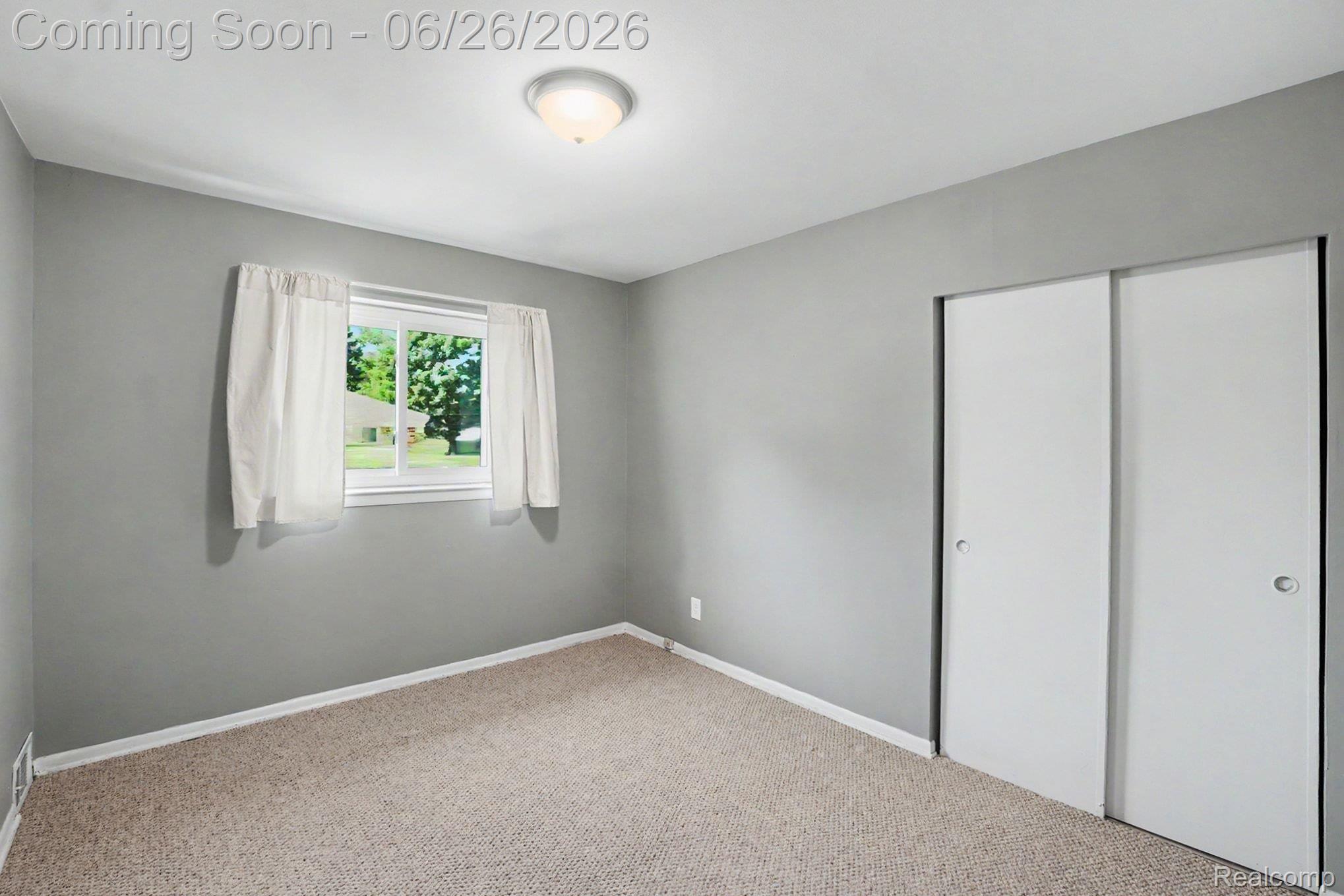1209 Massoit Road Clawson, MI 48017 - Photo 17 of 25 Room featuring neutral gray walls, beige carpet flooring, and white trim