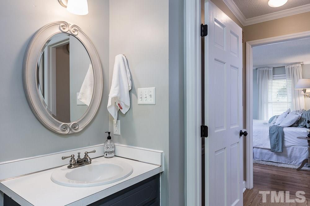 1590 Ranch Road Clayton, NC 27520 - Photo 13 of 26 a bathroom with a sink and a mirror