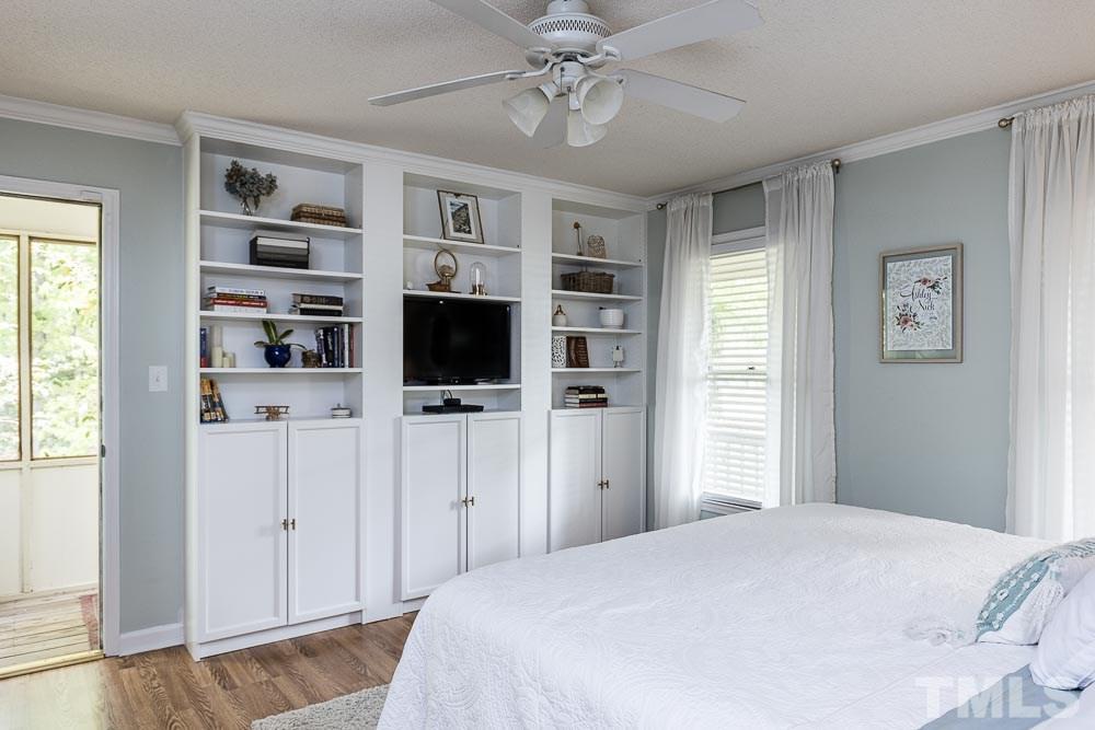 1590 Ranch Road Clayton, NC 27520 - Photo 14 of 26 a bedroom with a bed and a flat screen tv