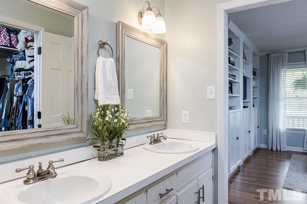 1590 Ranch Road Clayton, NC 27520 - Photo 17 of 26 a bathroom with a sink and a mirror