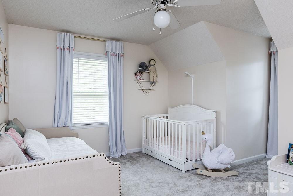 1590 Ranch Road Clayton, NC 27520 - Photo 18 of 26 a bedroom with a bed and a window